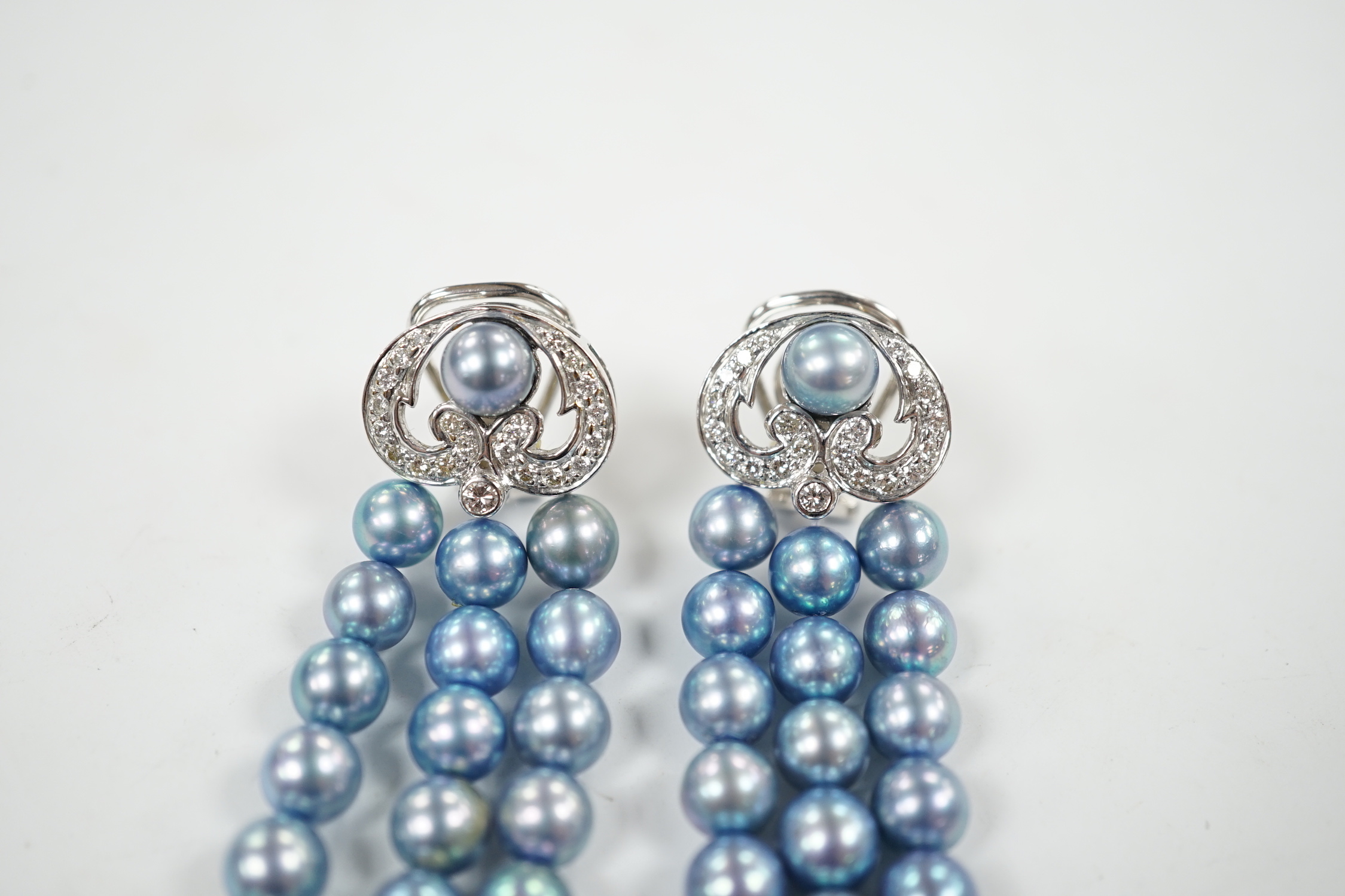 A modern pair of white metal, diamond chip cluster and bluey/grey three row cultured pearl tassel drop earrings, 89mm.